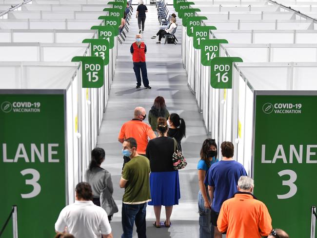 People queue up to receive the Pfizer Covid-19 vaccine at the community vaccination hub at the Brisbane Entertainment Centre in Boondall. Picture: NCA NewsWire / Dan Peled