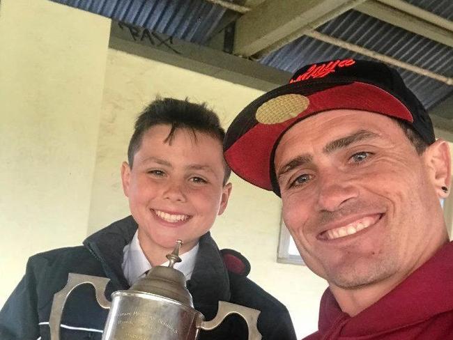 Rockhampton's Braelan Marsh celebrates his national title win with dad PJ Marsh, a former Origin and NRL player. Picture: CONTRIBUTED