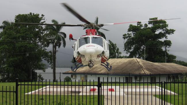 A Queensland Rescue helicopter landing at the Innisfail Hospital's helipad.