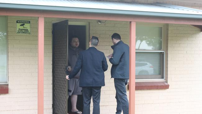 Police speak to Buzzby Barfoot the morning after his mother was found with traumatic head injuries near their home. Picture: Dean Martin