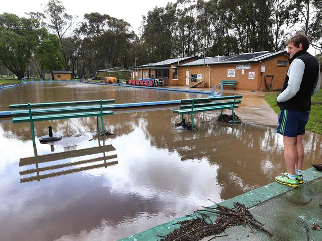 Flooding of the North Para River in the Barossa. Craig Wilson, who manages the Nuriootpa swimming pool, waits for flood water to subside. Picture: Dean Martin