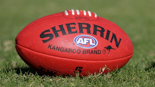 Generic AFL Sherrin football and football boots. sport /