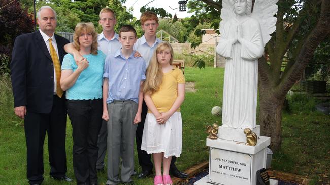 Tina and Chris Dear with their four children next to Matthew’s grave.