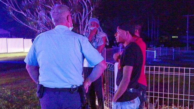 Police speak with residents of Eileen Drive, Corindi Beach, after a house fire Tuesday night. Picture: Frank Redward