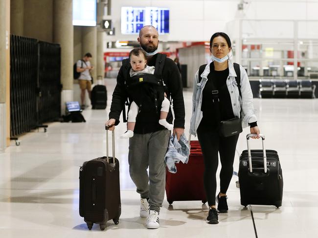 John Brodie, Sofia Brodie, 1, and Erika Orlaineta pictured arriving from Melbourne at the Brisbane Domestic Airport. (Image/Josh Woning)