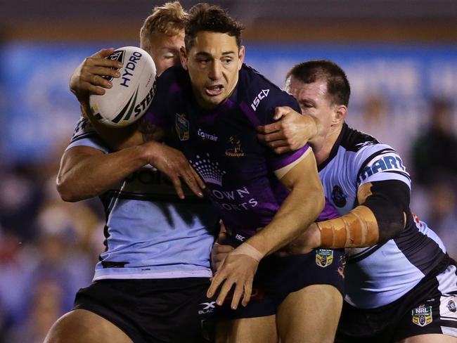 SYDNEY, AUSTRALIA - JUNE 08:  Billy Slater of the Storm is tackled during the round 14 NRL match between the Cronulla Sharks and the Melbourne Storm at Southern Cross Group Stadium on June 8, 2017 in Sydney, Australia.  (Photo by Matt King/Getty Images)