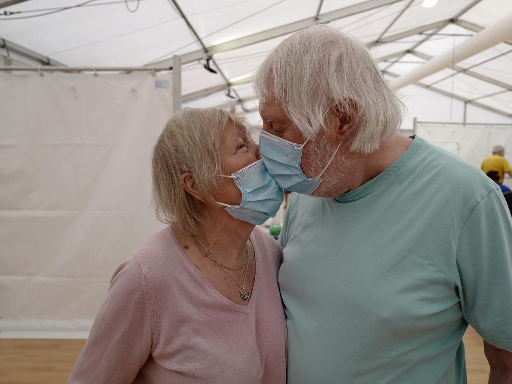 Ian Robertson, 80, and Margaret Robertson, 82, partners for over forty years, kiss after receiving their COVID-19 vaccinations on January 26 near Truro in Cornwall, southwest England. Picture: Hugh Hastings/Getty Images