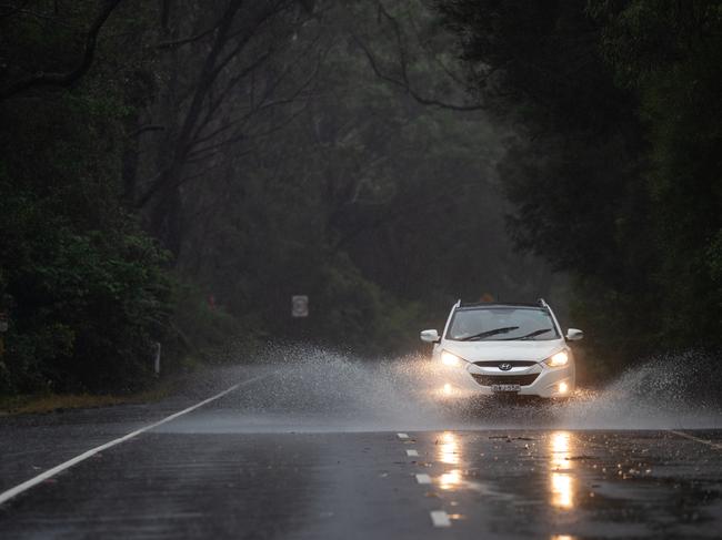 Generic scenes on The Northern Beaches on 20th March 2021 as the forecast 'rain bomb' of wet weather hits Sydney. Cars driving through rainwater on The Wakehurst Parkway just before the section of the road that was closed. (Pictures by Julian Andrews).