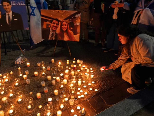People gather to light candles in a makeshift memorial to honour Yaron Lischinsky and Sarah Milgrim. Picture: AP Photo