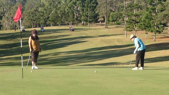 Lydia Costello watches on as Lorraine sinks her last putt in Saturday's comp.