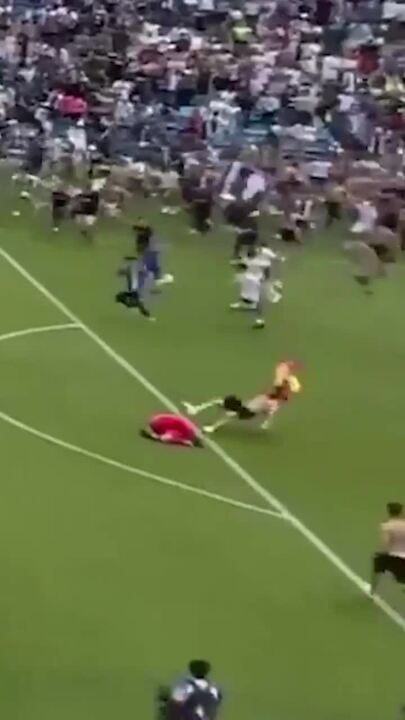 Football pitch invader takes out goalkeeper