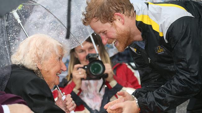 A drenched Prince Harry in 2017 made a beeline for war widow Daphne Dunne during his 2017 visit. Picture: Toby Zerna