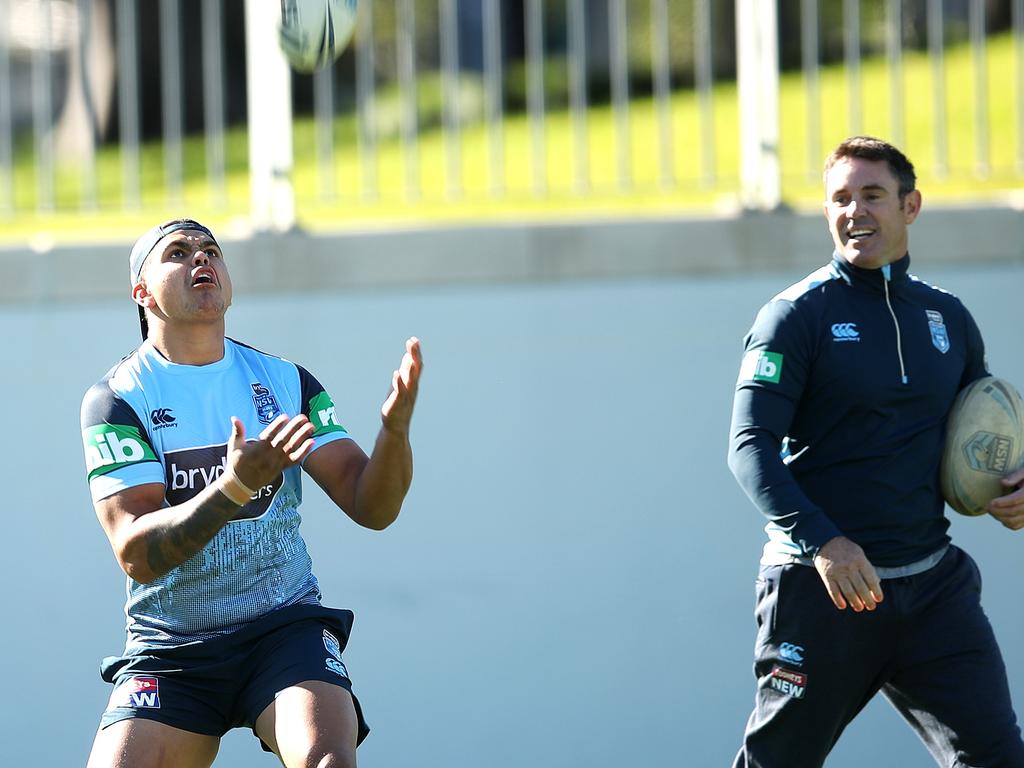 Latrell Mitchell catches a high ball at Blues training with Brad Fittler watching on.