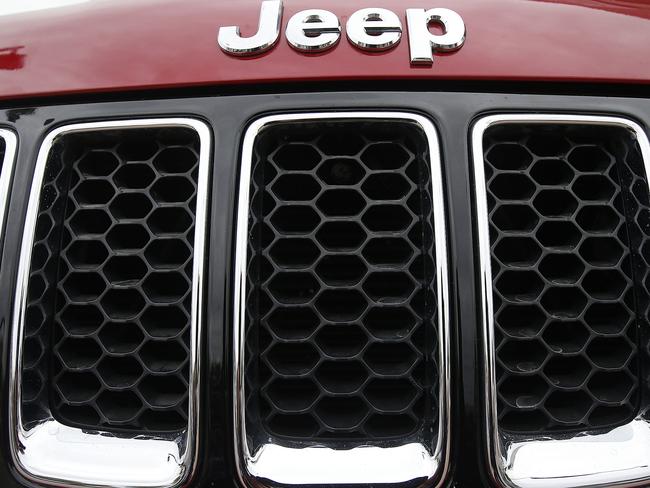 FILE - This Tuesday, Dec. 2, 2014, file photo, shows the Jeep logo on a Cherokee vehicle at a local car dealership in Tempe, Ariz. Fiat Chrysler is recalling nearly 94,000 SUVs because the air conditioning lines are too close to the exhaust manifold and could catch fire, the company announced, Tuesday, Oct. 27, 2015. The company looked into the problem after U.S. regulators got two complaints about smoke and fire in certain 2015 Jeep Cherokees. (AP Photo/Ross D. Franklin, File)