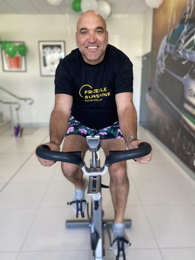 Rugby legend Gorden Tallis at Frizelle Sunshine Automotive in Southport riding a spin bike to raise money for the Children's Starlight Foundation Tour De Kids. Photo: Supplied