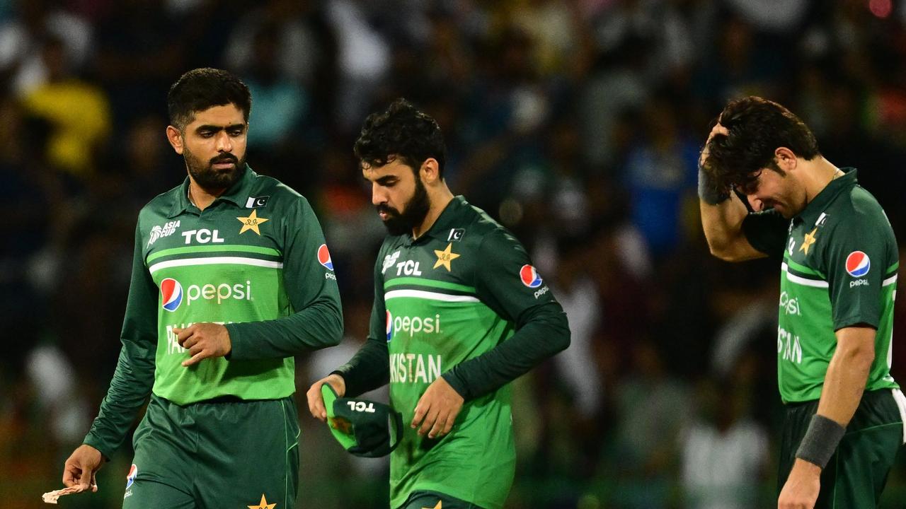 Pakistan's captain Babar Azam (L) and team mates react as they walk back to the pavilion after Sri Lanka's victory