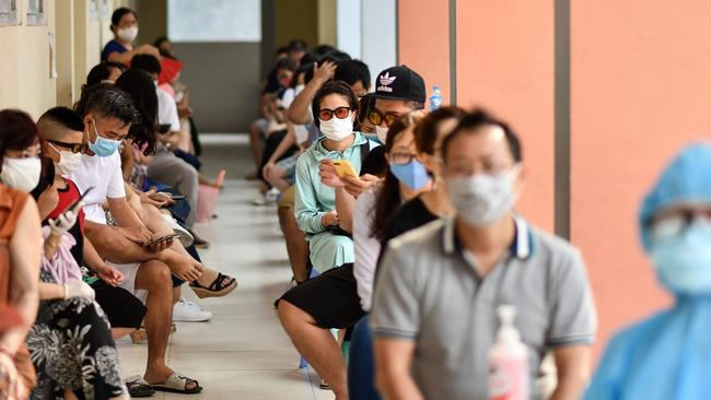 Residents wait to be tested at a makeshift rapid testing centre in Hanoi. Picture: AFP.