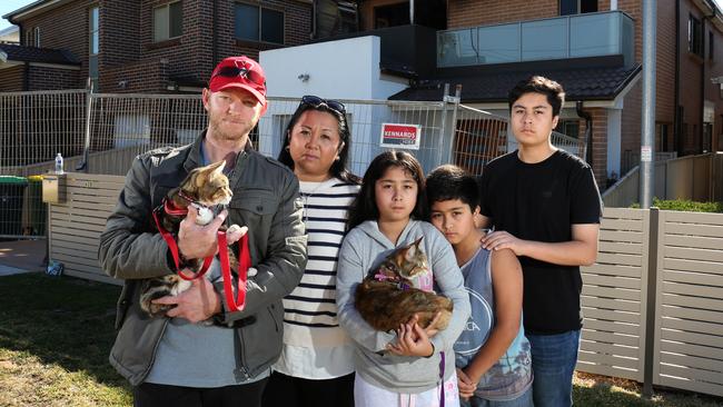 Chris Dunlop and Nerissa Long, seen with their children Ariyanna, Nathaniel (11), Charles (15) and their cats Tails and Assami, are being helped by the community to get back on the feet, after the devastating fire. Picture: Robert Pozo