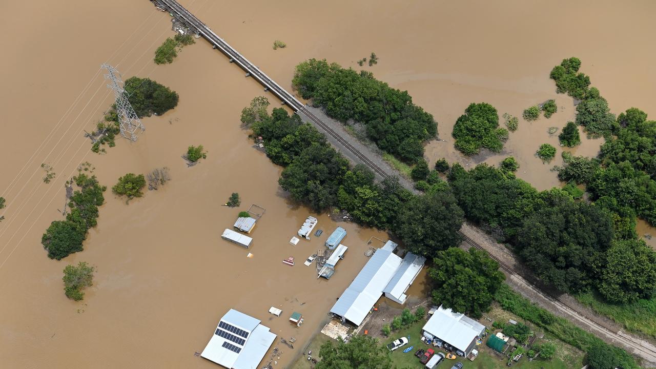 Train lines are cut off as floodwaters surround Gympie on February 27, 2022. Photo: Bradley Kanaris/Getty Images