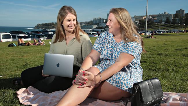 Lauren McLaren and Sarah Oram create a makeshift office at Bondi Beach. Picture: Adam Yip