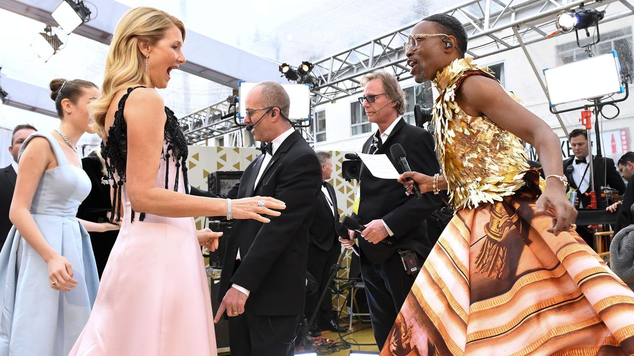 Laura Dern (left) is either clearly impressed, or too polite to say otherwise, after seeing Billy Porter’s outfit. Picture: AFP