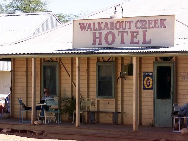 Paul Hogan sits on the veranda of the re-constructed Walkabout Creek hotel on location in McKinlay during the filming of Crocodile Dundee 3. Picture: News Corp