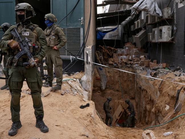 Israeli soldiers stand near the opening to a tunnel at al-Shifa Hospital compound in Gaza City. Picture: Reuters.