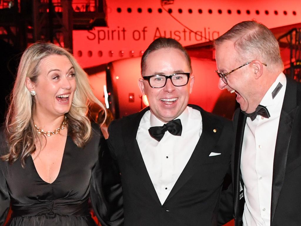 Alan Joyce, Anthony Albanese and his partner Jodie Haydon share a joke at the Qantas 100th Gala Dinner in 2023. Picture: James D. Morgan/Getty Images