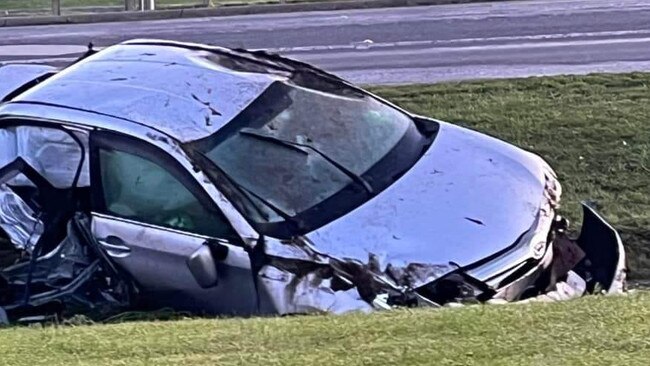 A silver Toyota Corolla was pushed into a drainage ditch.