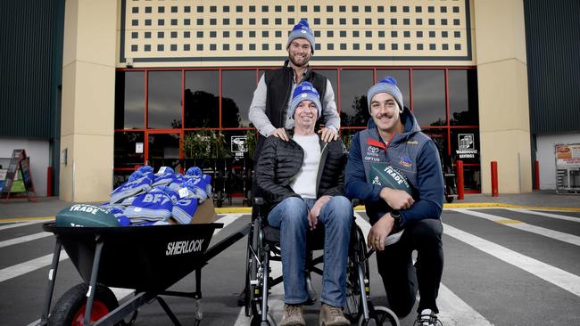 Former Crows player Mitch Grigg with his dad Chris Grigg and Crows star Taylor Walker at Bunnings Mile End to promote the Big Freeze charity fundraiser. Picture: Naomi Jellicoe