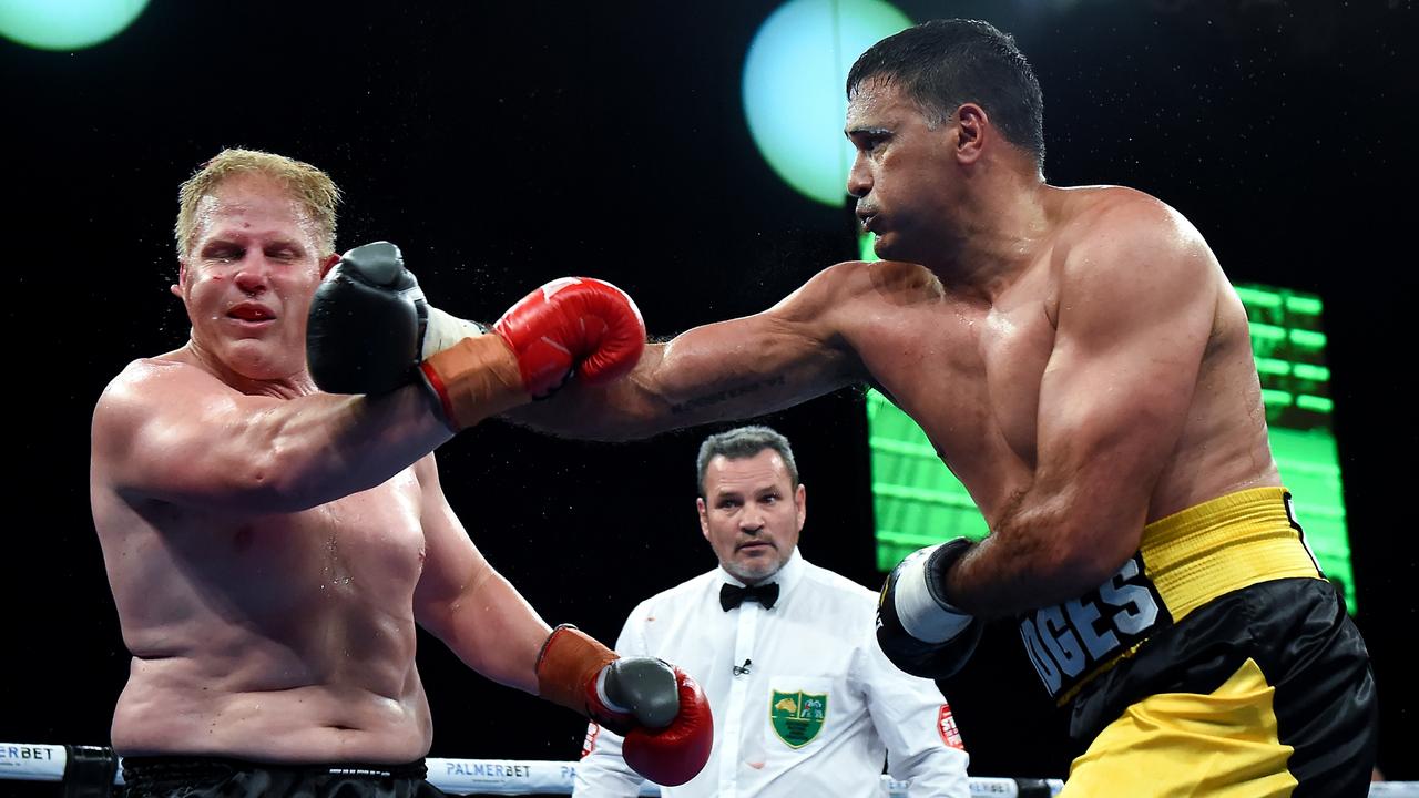 Justin Hodges lands a big right hand on Ben Hannant on his way to victory in their fight at Brisbane Convention &amp; Exhibition Centre. Picture: Albert Perez/Getty Images