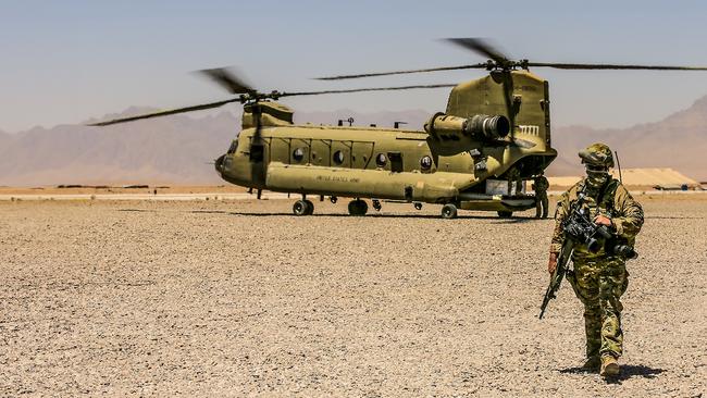 Ex Australian Army photographer, Chris Moore, exits CH-47 Chinook at Tarin Kowt flight line . Supplied