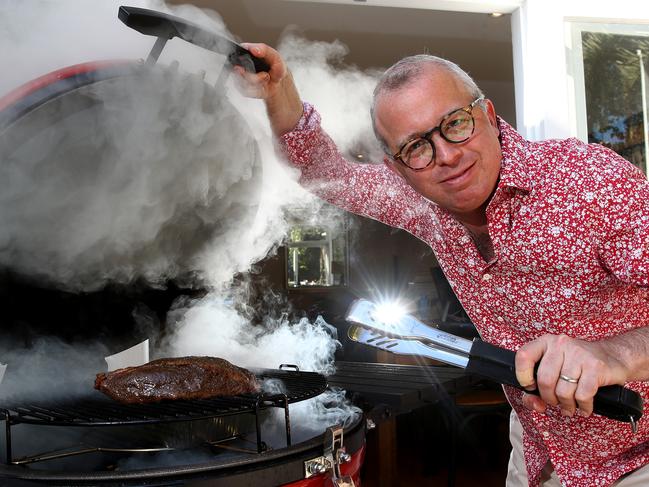 Daily Telegraph journalist James Morrow has taken up the hobby of smoking meats during his time in isolation due to the coronavirus. Pictured at his Petersham home smoking some meat. Picture: Toby Zerna