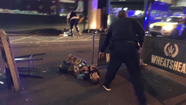 Armed police stand over two of the terrorists after shooting them outside the Wheatsheaf pub near Borough Market. Picture: AFP/Gabriele Sciotto