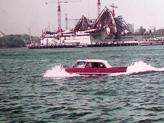 An Amphicar demonstration in Sydney Harbour in front of a half finished Opera house in the 1960s.