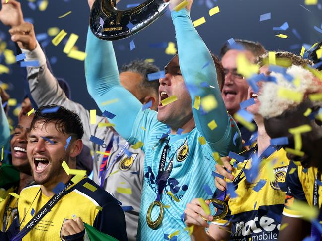 GOSFORD, AUSTRALIA - MAY 25: Danny Vukovic of the Central Coast Mariners holds aloft the Championship Trophy alongside team mates after winning the A-League Men Grand Final match between Central Coast Mariners and Melbourne Victory at Industree Group Stadium on May 25, 2024, in Gosford, Australia. (Photo by Mark Metcalfe/Getty Images)