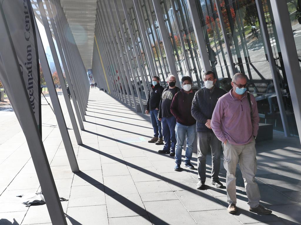 People wait to receive their Covid vaccine jab at the Melbourne Convention centre on Sunday. Picture: David Crosling