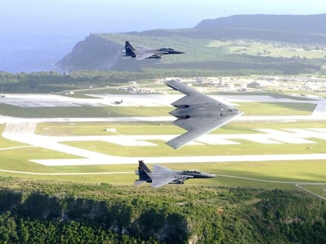 F-15E Strike Eagles and a B-2 Spirit bomber fly in formation over Andersen Air Force Base, in the north of the island. Picture: Cecilio Ricardo/US Air Force