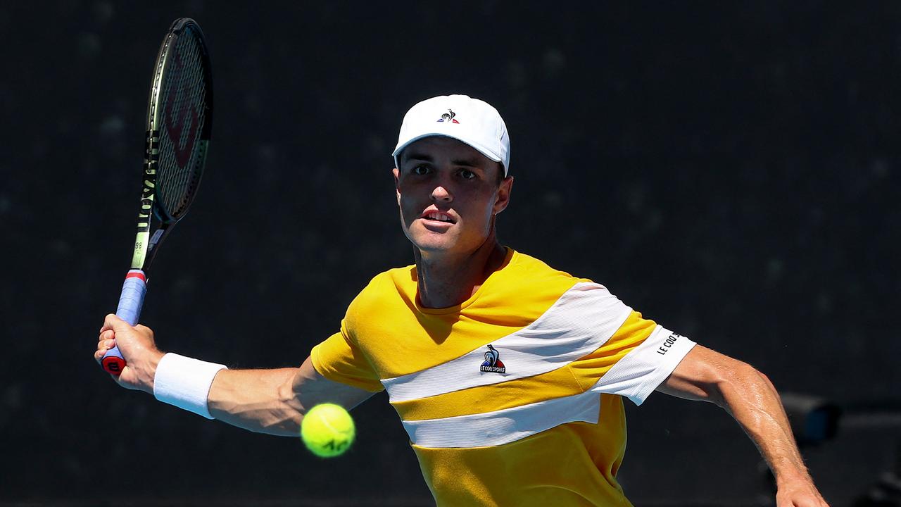 Australia's Christopher O'Connell hits a return against Argentina's Diego Schwartzman during their men's singles match on day four of the Australian Open tennis tournament in Melbourne on January 20, 2022. (Photo by Aaron FRANCIS / AFP) / -- IMAGE RESTRICTED TO EDITORIAL USE - STRICTLY NO COMMERCIAL USE --
