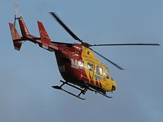 The Westpac rescue helicopter flies low over Lauderdale. Picture: MATHEW FARRELL