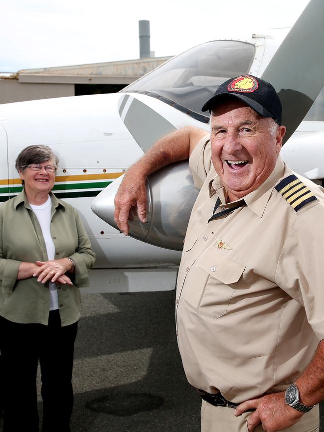 Dick Lang with his wife Helen and one of their planes at Parafield Airport. Picture: Calum Robertson
