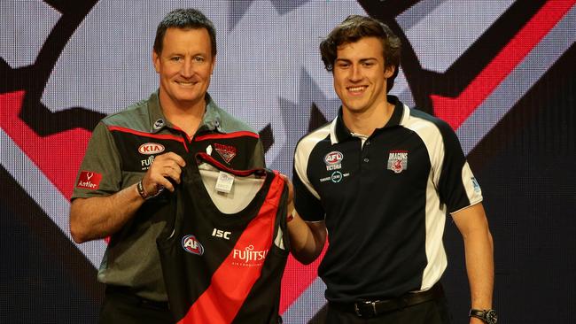 Andrew McGrath is presented with his Essendon by Bombers coach John Worsfold. Picture: Jonathan Ng