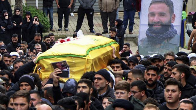 Mourners carry the coffins of Hezbollah fighter Ali Bazzi during a funeral procession in Bint Jbeil, Lebanon, on December 27. Picture: AFP