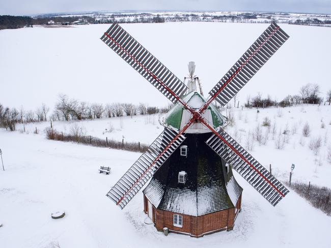 Picture taken with a drone shows a windmill in Stove, northeastern Germany, covered in snow on February 27, 2018. A blast of Siberian weather dubbed “The Beast from the East” sent temperatures plunging across much of Europe. Picture: AFP