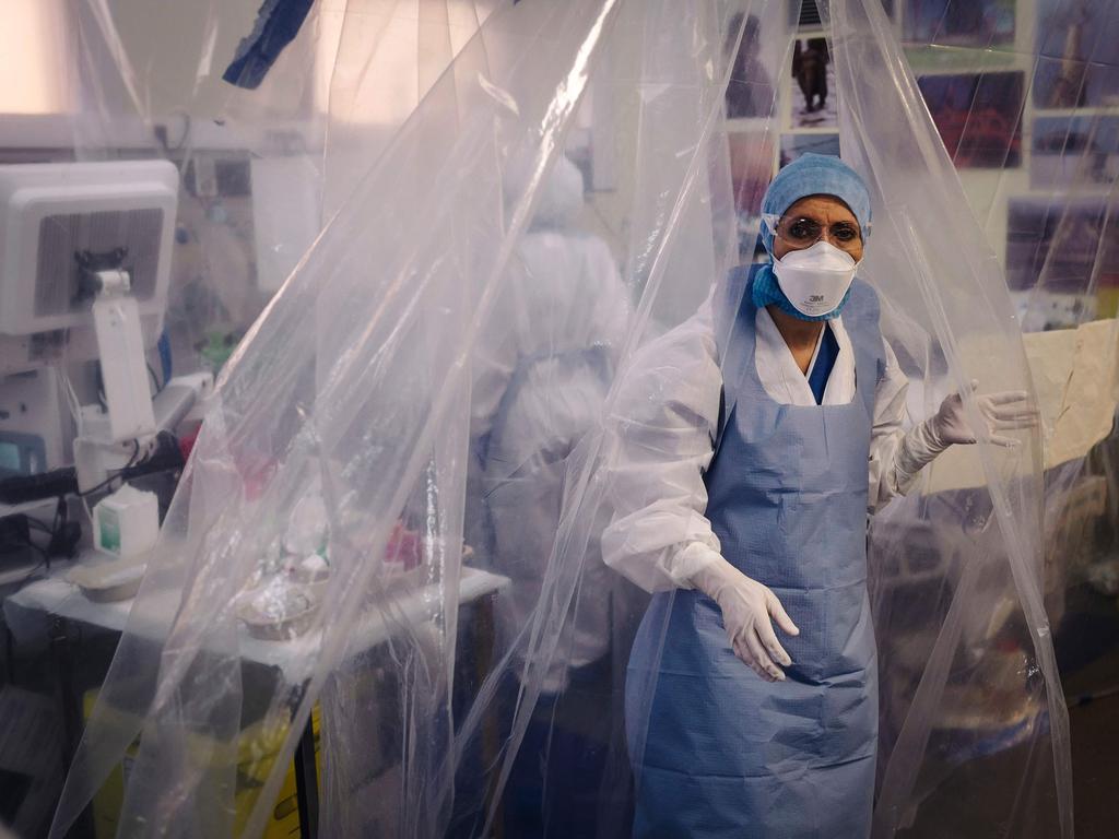 A medical staff member exits a room protected by a transparent tarpaulin after taking care of a patient infected with COVID-19 at the intensive care unit of a Paris hospital. Picture: LUCAS BARIOULET / AFP.