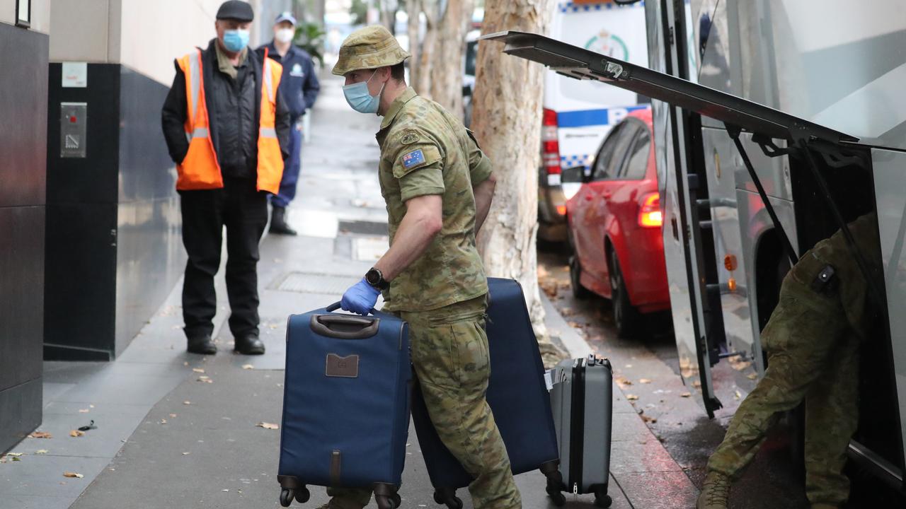 Other states and nations have been praised for their quarantine measures because they’re not using private contractors. In this photo, the ADF are taking luggage into the TraveLodge Hotel in Sydney. Picture: Tim Hunter.