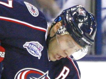 Columbus Blue Jackets' Jack Johnson (7) keeps the puck away from Toronto Maple Leafs' Nazem Kadri (43) in the second period of an NHL hockey game, Friday, Oct. 31, 2014, in Columbus, Ohio. Toronto won 4-1. (AP Photo/Mike Munden)