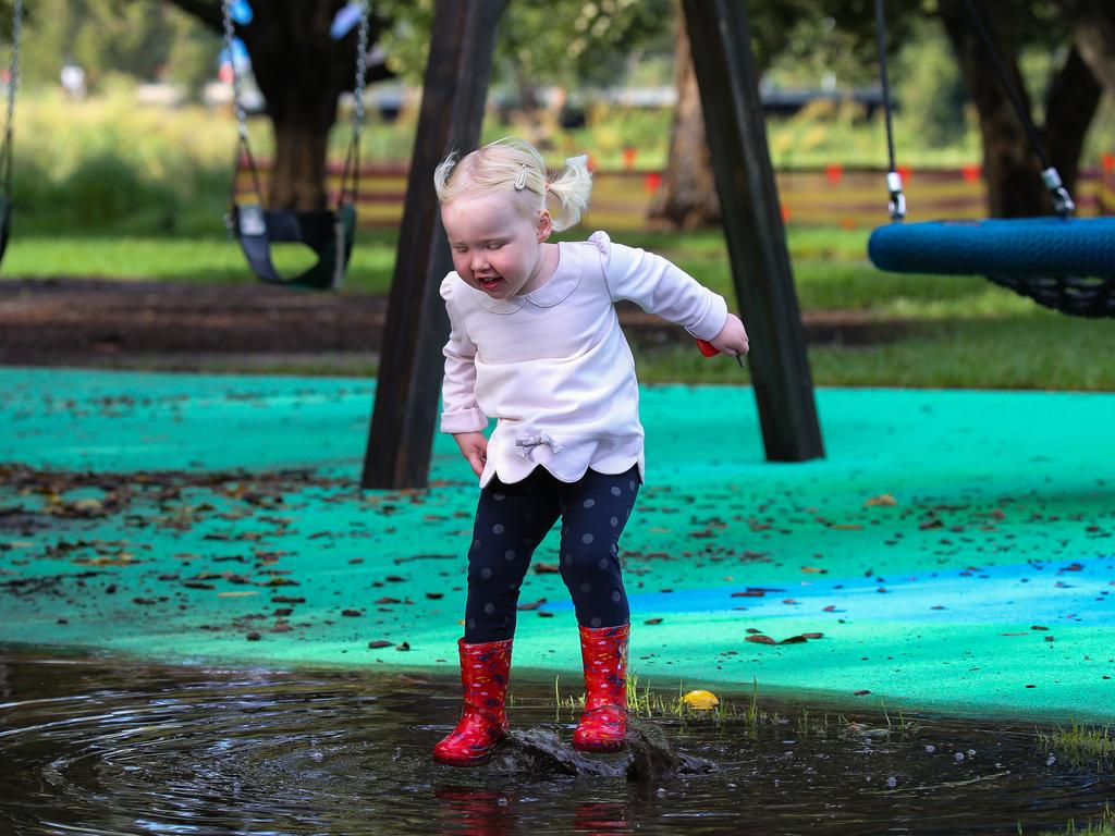 Two-year-old Aoife Fallon plays in the puddles at Centennial Park on Sunday morning during a break from the rainfall. Picture: Gaye Gerard