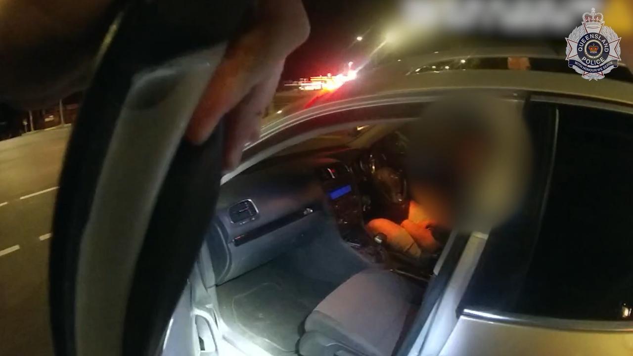 Bodycam footage of the moment Queensland Police allegedly found a 21yo man asleep at the wheel, stopped at traffic lights.