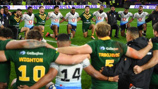 Australia and Fiji players huddle together following their Rugby League World Cup Pool B match at Headingley. Picture: Gareth Copley/Getty Images